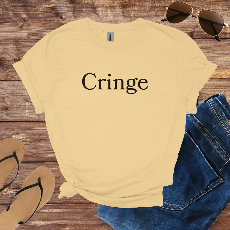 Beige t-shirt with 'Cringe' text on a wooden surface with sunglasses, jeans, and flip-flops.