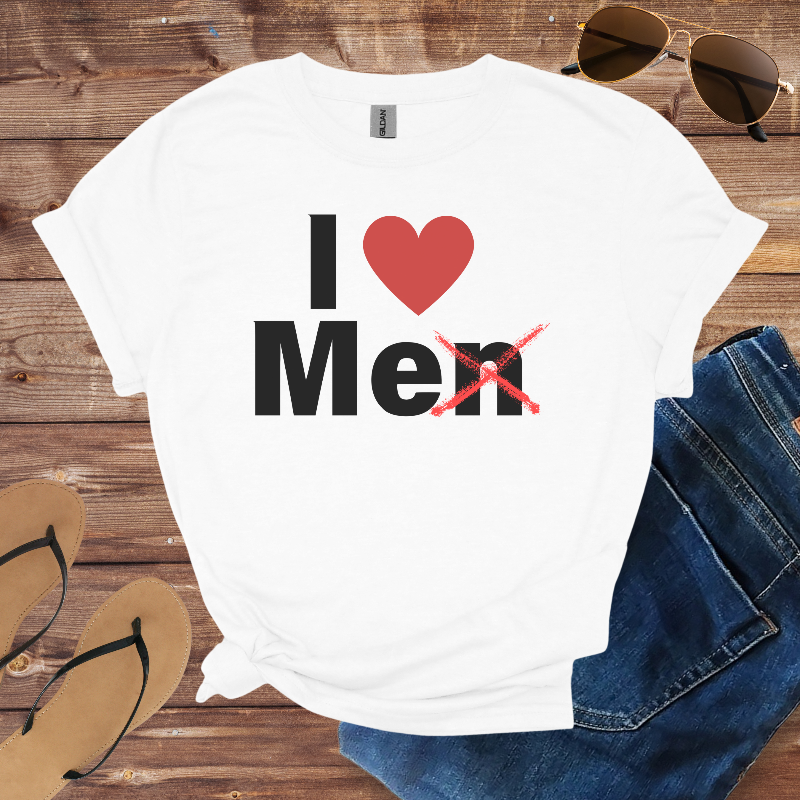 White t-shirt with 'I ❤️ Men' design on a wooden surface with sunglasses, jeans, and sandals.