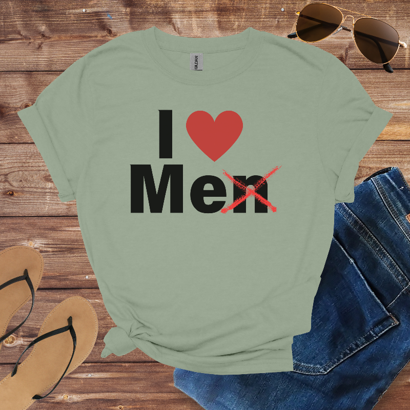 Green t-shirt with 'I ❤️ Men' text on a wooden surface with sunglasses, jeans, and sandals.