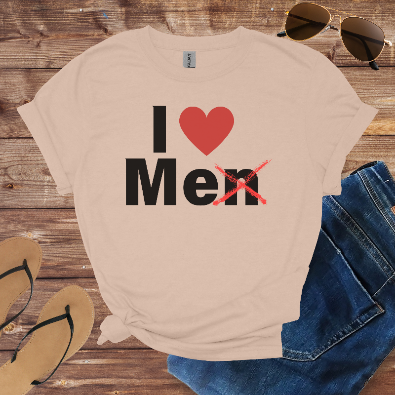 Beige t-shirt with 'I ❤️ Men' text on a wooden surface with sunglasses, jeans, and flip-flops.
