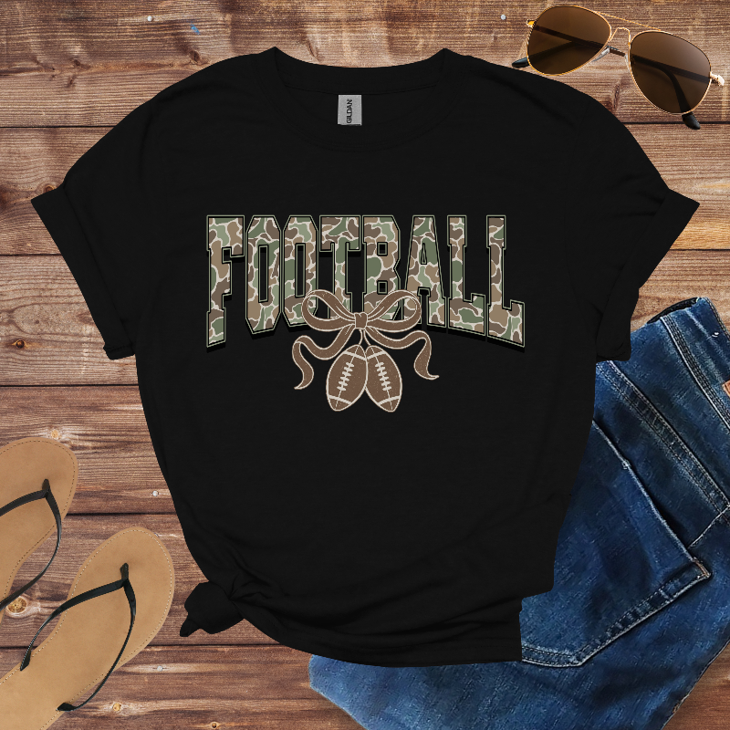 Black t-shirt with 'FOOTBALL' print on a wooden surface with sunglasses and jeans.