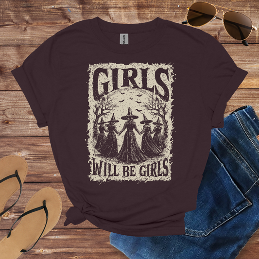 Dark chocolate t-shirt with a graphic of four witches and the text "Girls Will Be Girls."