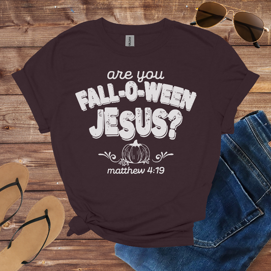 Brown t-shirt with 'are you Fall-o-ween Jesus?' text on a wooden surface with sunglasses, jeans, and flip-flops.